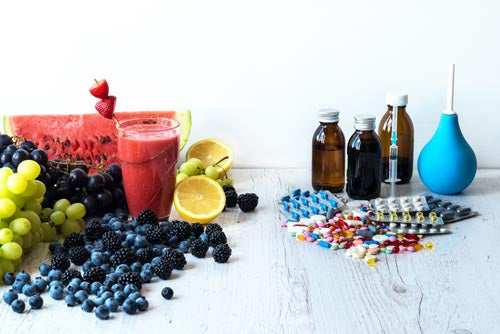 Enema products and healthy foods on a table